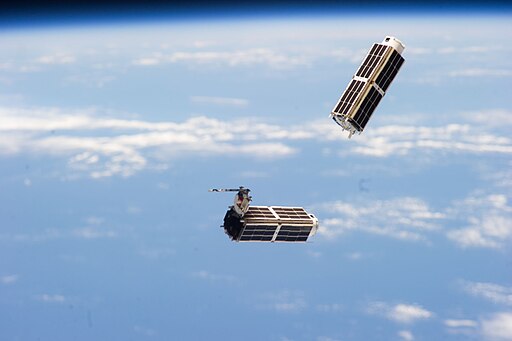 An image taken from the ISS of some small cube satellites