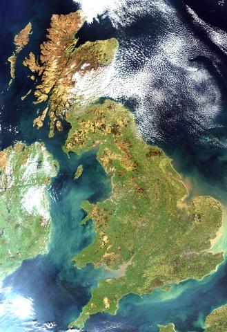 Satellite image showing the United Kingdom, with Scotland, England, Wales, and Northern Ireland visible. Surrounding waters and some clouds are seen in the top right corner