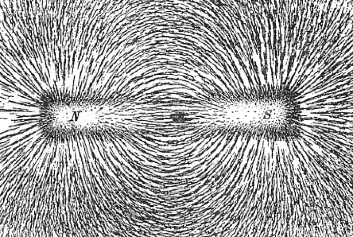 An outline of a bar magnet with "N" at one side and "S" at the other. Lines arc in the centre to connect each side, and more lines come out of the end of each. These lines are black and appear fuzzy because they are made from iron filings.